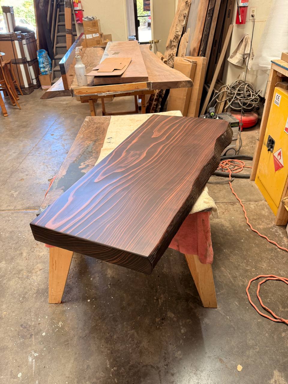 50 by 20 inch solid redwood bench seat in walnut stain, photographed in the FamilyWood workshop