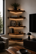 A set of five rustic, floating wooden shelves mounted on a wall in a modern living room. The shelves are styled with books, vases, and plants, and are illuminated by warm built-in LED under-shelf lighting.