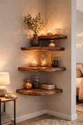 Three rustic live-edge wooden floating shelves mounted on a beige wall in a bedroom corner, styled with candles, glass jars, a vase with greenery, and books.