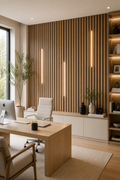 Modern office with wooden desk, chair, and shelves with decor items.